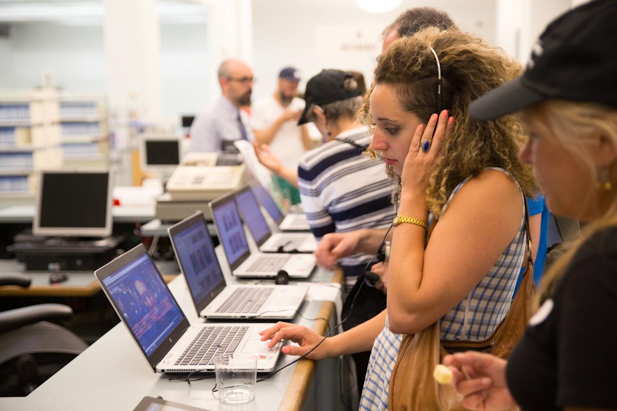 Women reading at Heiskell Library, on a laptop with headphones in Manhattan, New York City