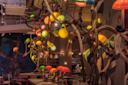 A restaurant interior decorated with colorful, glowing mushroom-shaped lamps and twisting wooden branches, creating a whimsical, fantasy-like atmosphere. Warm lighting enhances the cozy, imaginative setting.