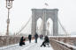 People on Brooklyn Bridge during snowfall