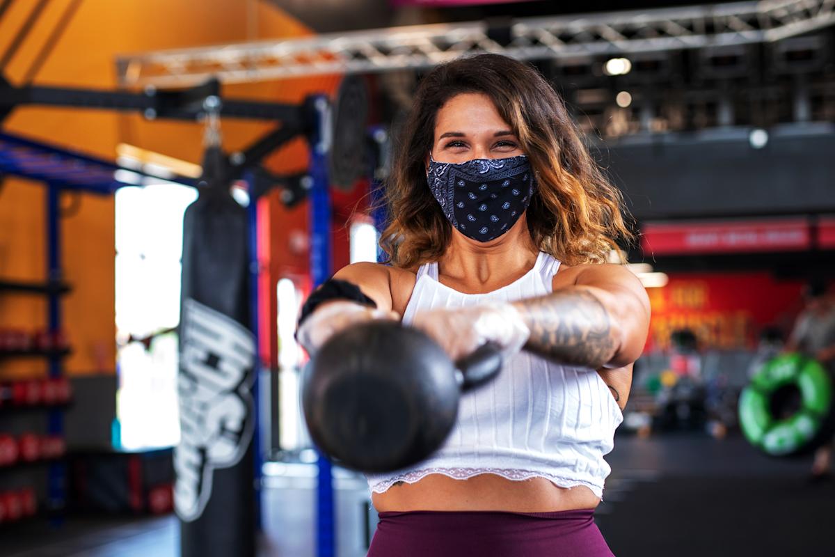 Person lifting weights inside Crunch Fitness Gym in NYC