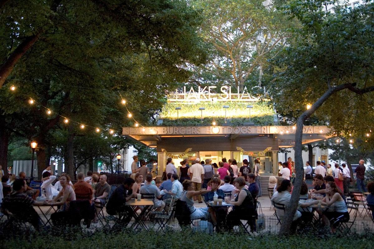 People eating in Shake Shack in Madison Square Park, NYC