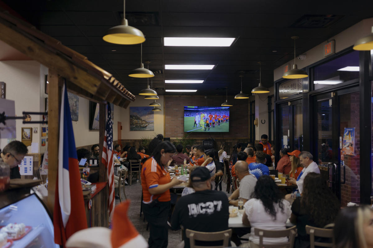 People dine and order food while waiting for the game to begin.