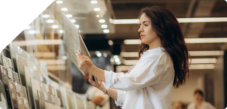 a woman choosing a tile in the store.