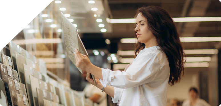 a woman choosing a tile in the store.