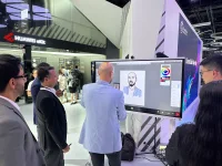 People looking at the portrait drawn on a Huawei display running Mago