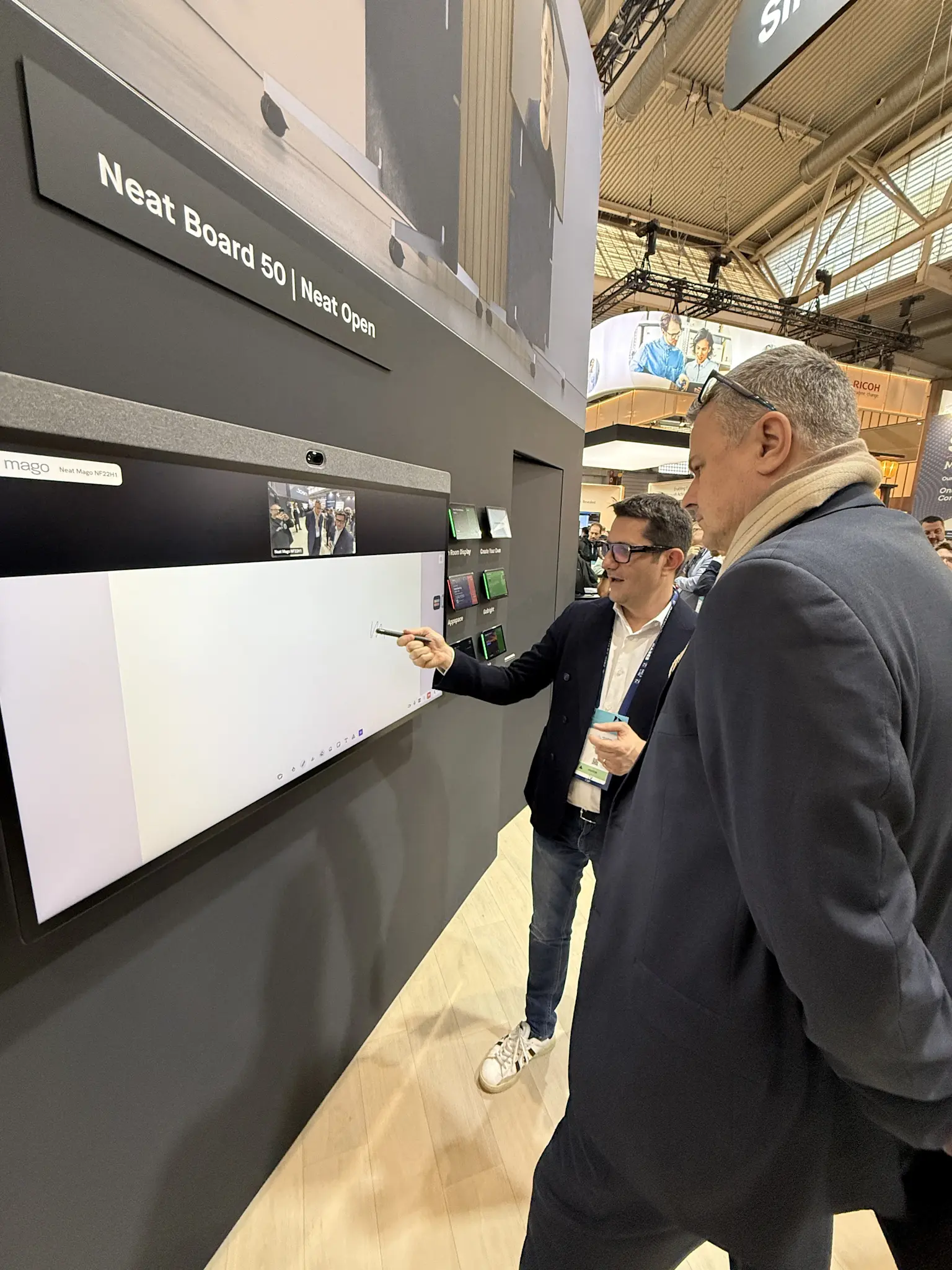 Person using a stylus on the Neat Board 50 whiteboard powered by Mago at ISE 2026