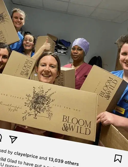 Smiling NHS workers hold up Bloom & Wild boxes.