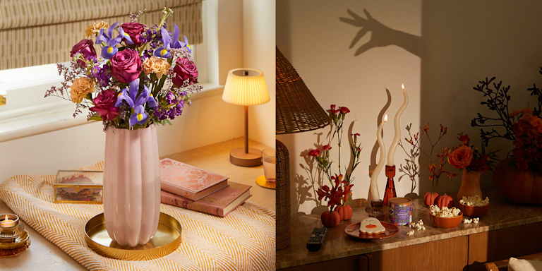 A stunning bouquet of deep purple roses, lilac irises, and peach carnations sits in a rippled pink glass vase. It evokes a feeling of calm and warmth.