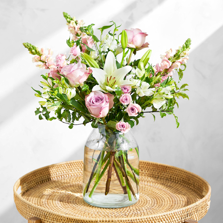 Bloom and Wild timeless bouquet featuring pink, green and white stems, including roses, snapdragons and lilies.