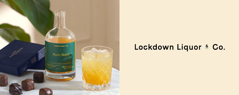 A Rum Rock cocktail in a chunky glass bottle, next to the Lockdown Liquor & Co logo