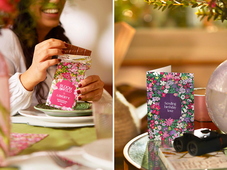 Close-up of a woman opening a Bloom & Wild x Liberty chocolate bar, alongside a matching floral greeting card.
