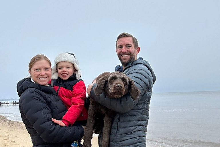 Ellie, Richard, Theo and their dog at the beach.