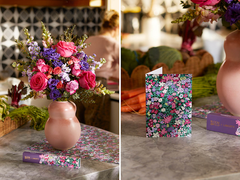 Pink vase with vibrant bouquet on a kitchen counter, alongside a floral card and chocolate bar.