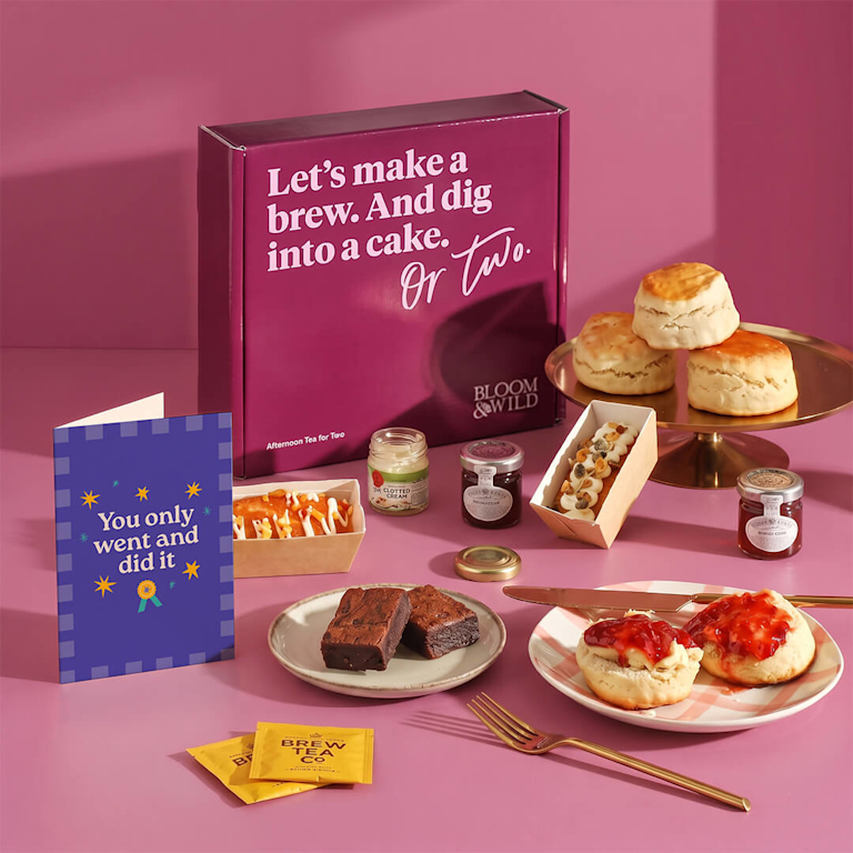 Afternoon tea gift box featuring warm scones, rich clotted cream, fruity jam, decadent chocolate brownies, tea, and a card reading "You only went and did it".