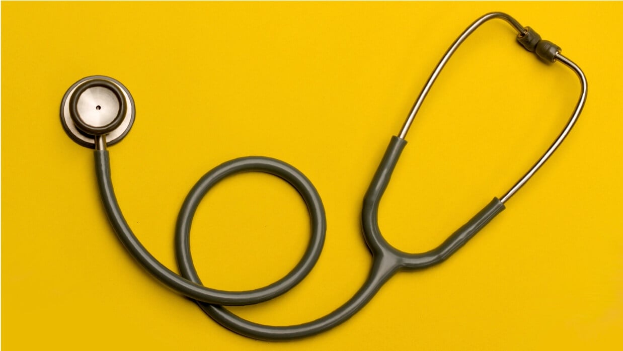 Stethoscope over yellow background