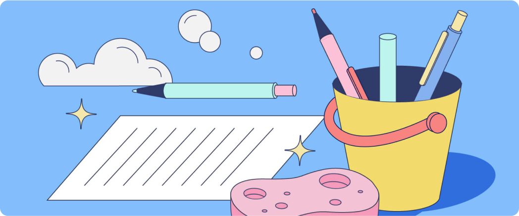 A bucket filled with pens and pencils. A sponge sits next to a sparkling piece of paper. 