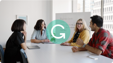 Boardroom of people with the Grammarly logo