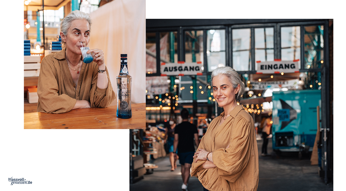 there is a woman sitting at a table with a bottle of water
