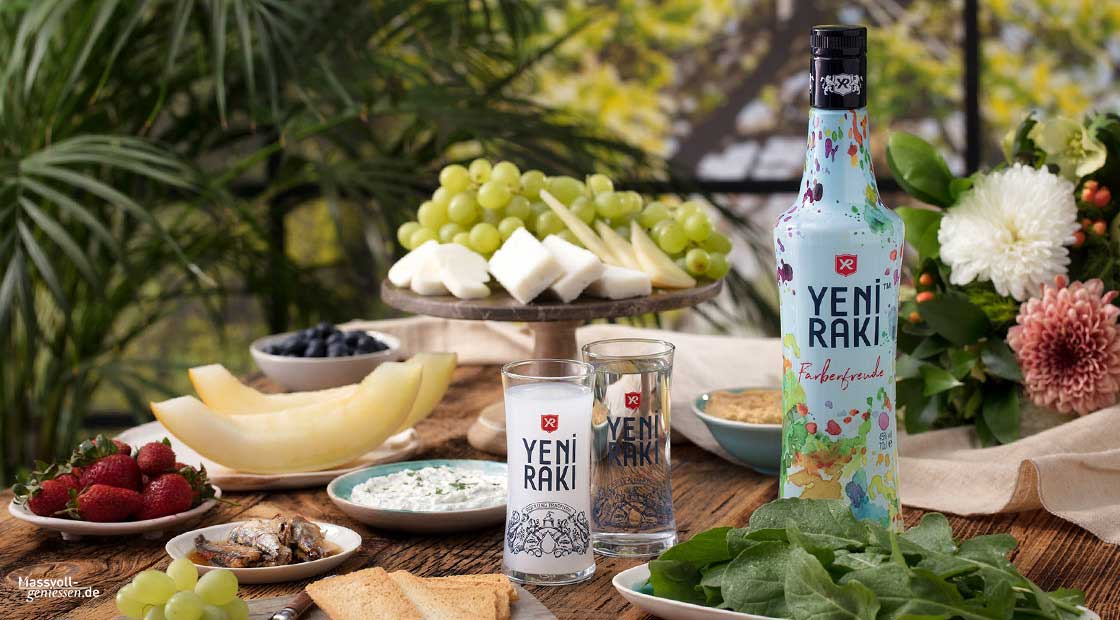 there is a bottle of vodka and a plate of fruit and vegetables