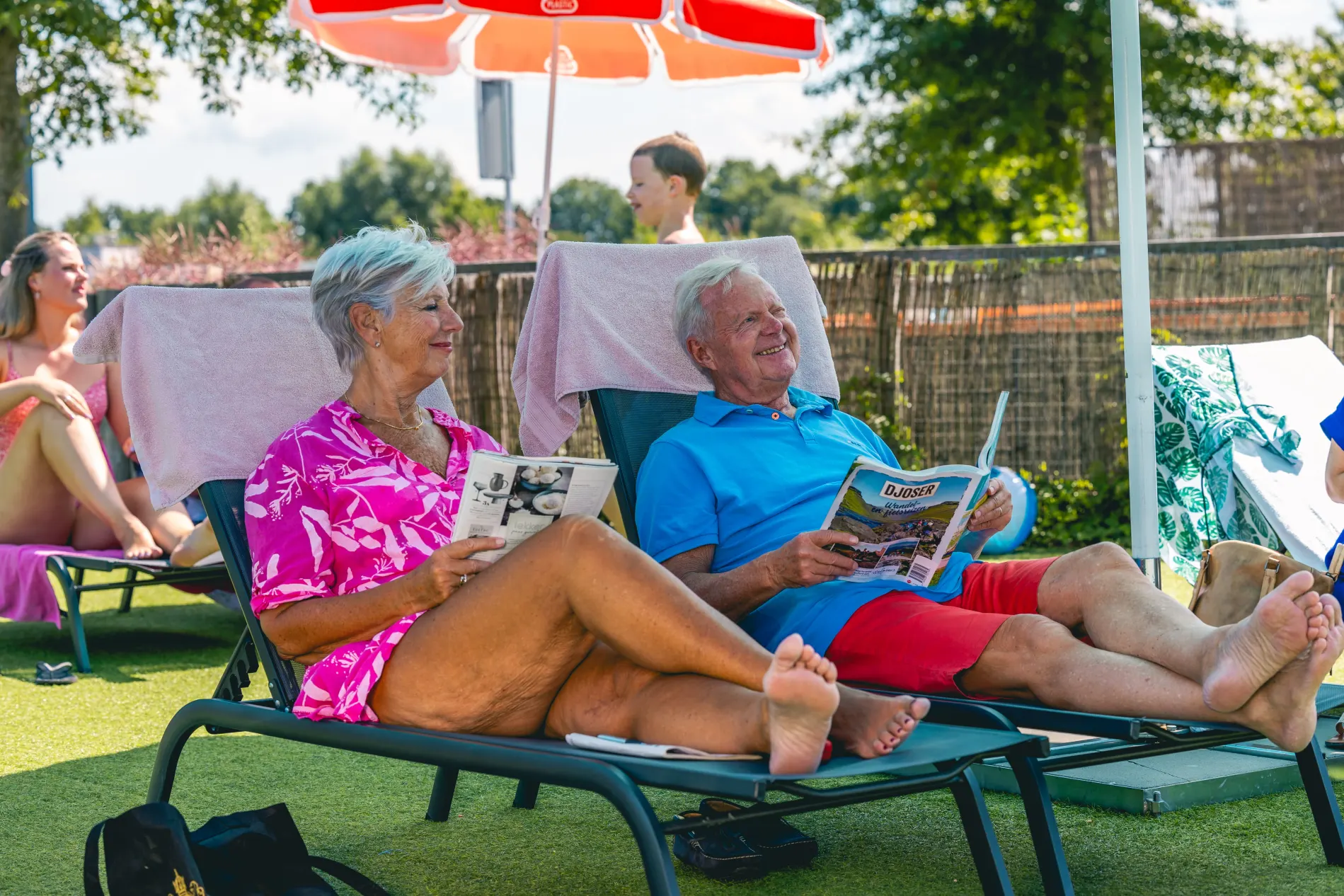 older couple grandparents relaxing at the pool