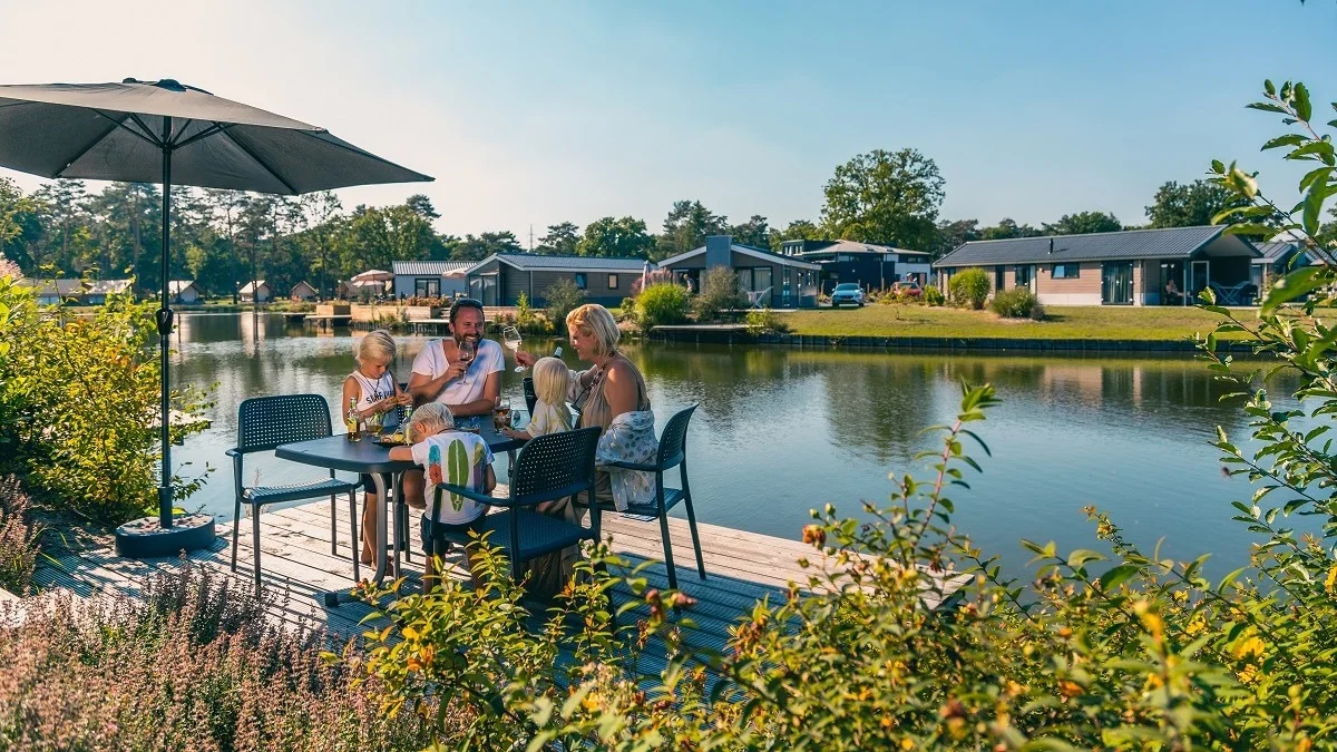 EuroParcs Zilverstrand Family enjoying the sun in their holiday home at the water