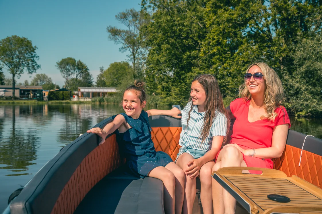 EuroParcs De Rijp surroundings family sitting in boat summer