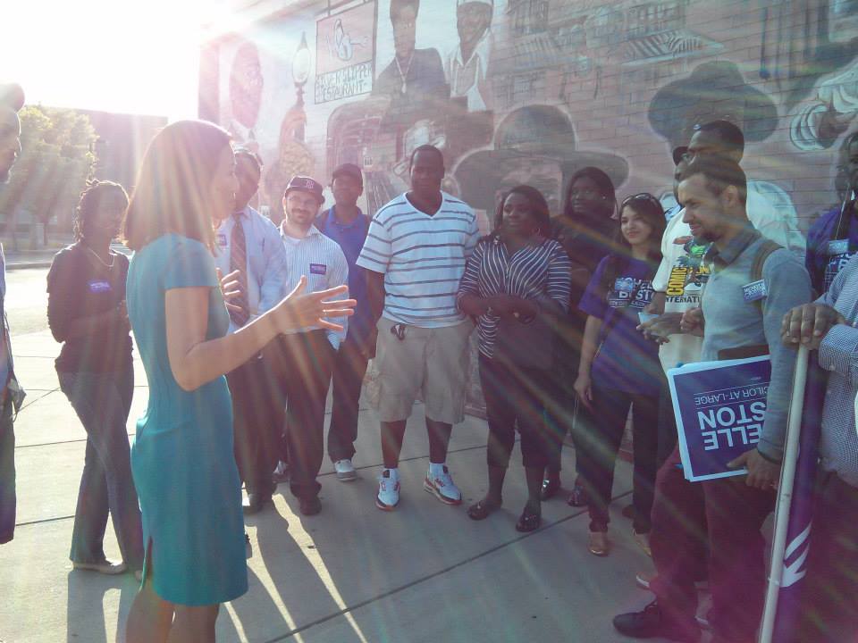 Michelle talks with a group of volunteers in Dudley Square on Juneteenth 2013.