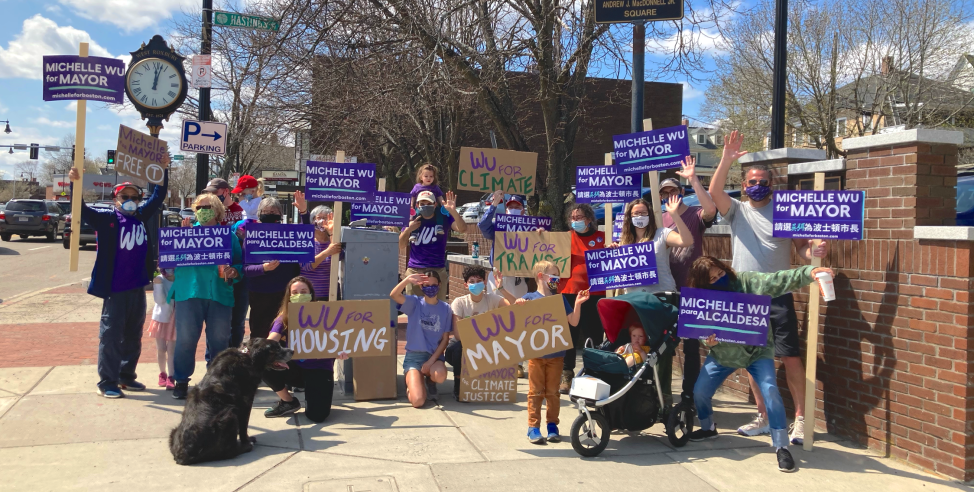 A large group of Wu volunteers pose with campaign signs.