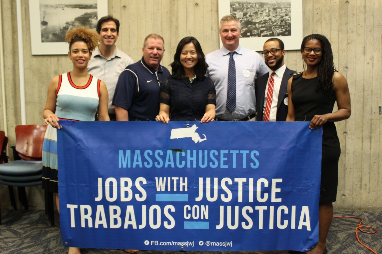 Michelle Wu and colleagues hold a Massachusetts Jobs with Justice banner.
