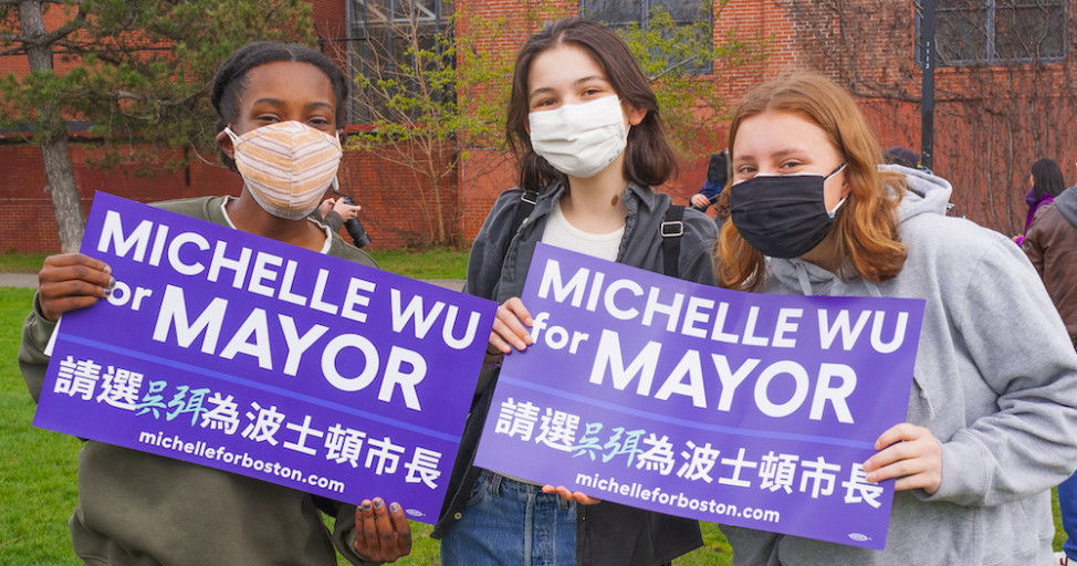 Members of Youth for Wu pose for a photo holding Michelle for Mayor signs.