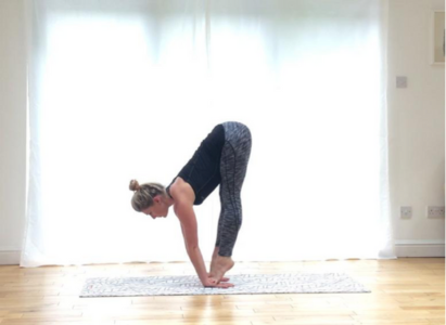 Image of woman doing standing forward bend pose