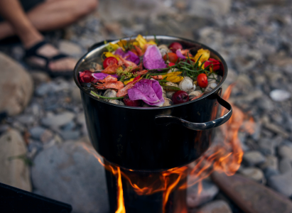 Foraged plants added to a cooking pot