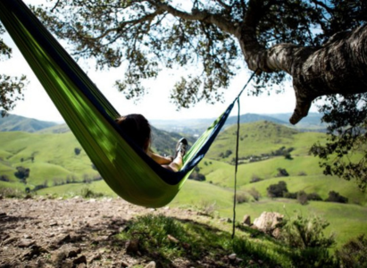 Camper relaxing in a hammock in the countryside