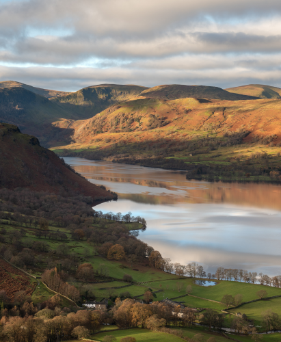 Beautiful morning light on Lake District mountains with calm Ullswater lake, taken from Hallin Fell.