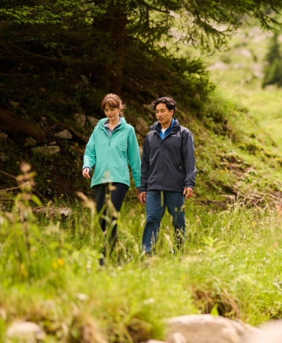 two people walking in the woods