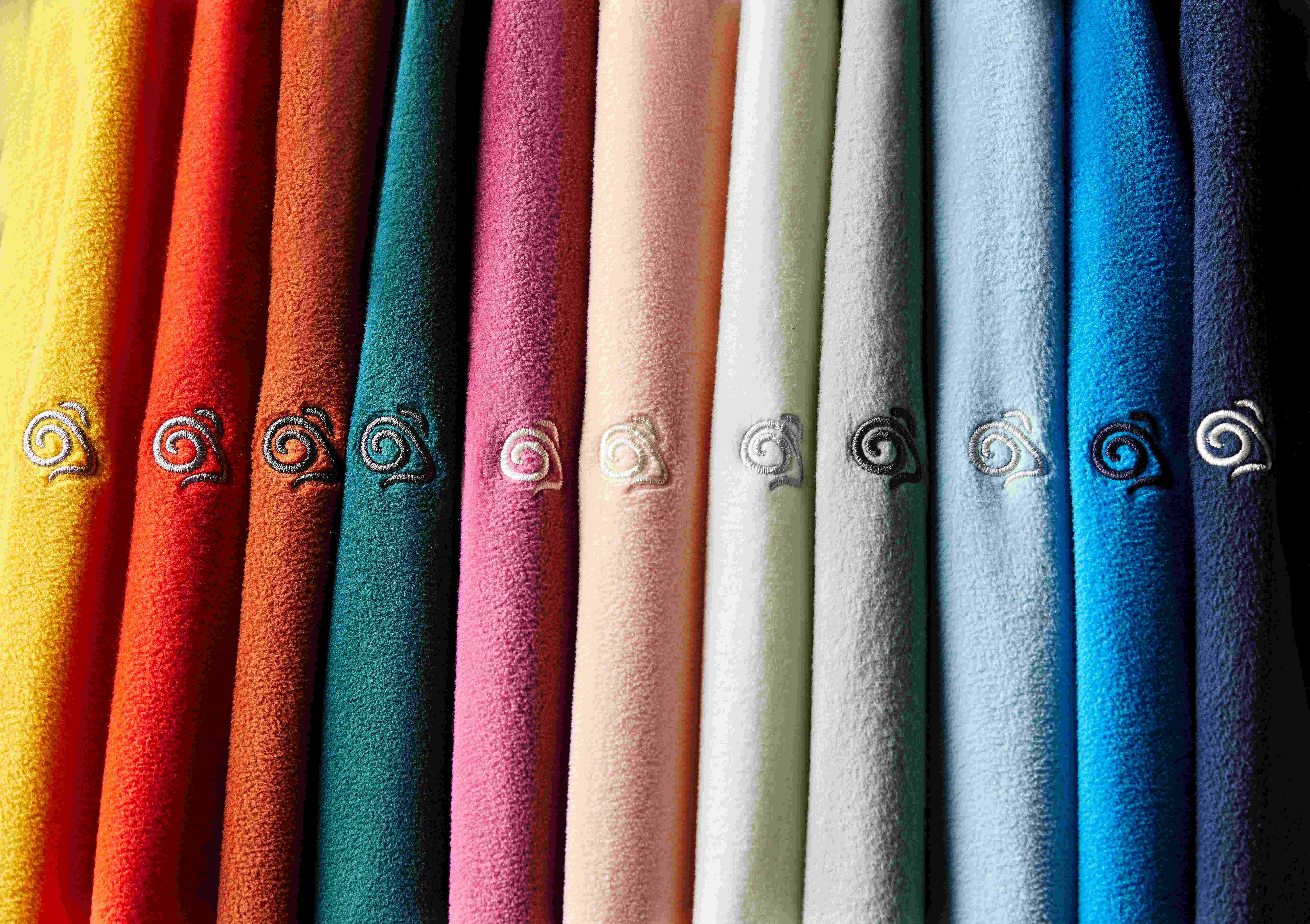 Craghoppers fleece, all different colours stacked next to each other showing the sleeve logo