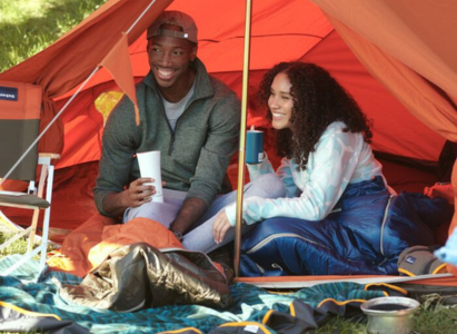 Couple in Tent with Camping Gear