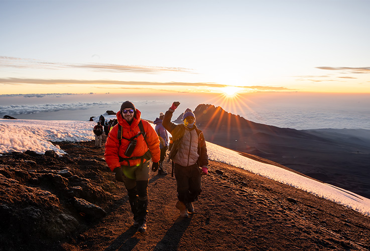 Two men climbing up Kilimanjaro