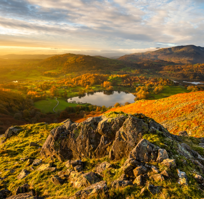 Beautiful Autumn colours at sunrise from Loughrigg Fell in the Lake District.