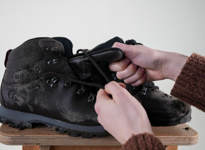 Removing laces and stretching the tongue of the walking boots ready for cleaning