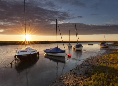A sunset view over the boats of Morston Quay