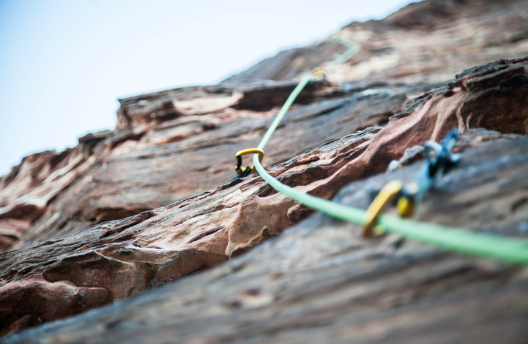 PITONS in a rock wall with rope