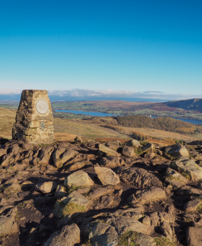 Triangulation pillar at the top of Gowbarrow Fell, overlooking Ullswater, Lake District, UK