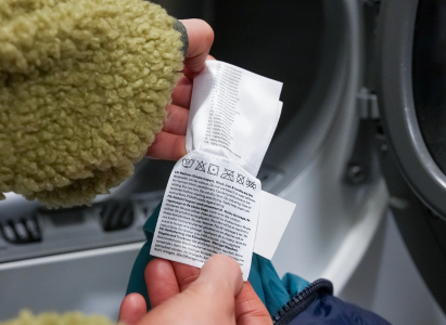 Checking the puffer jacket label ready to go in the washing machine