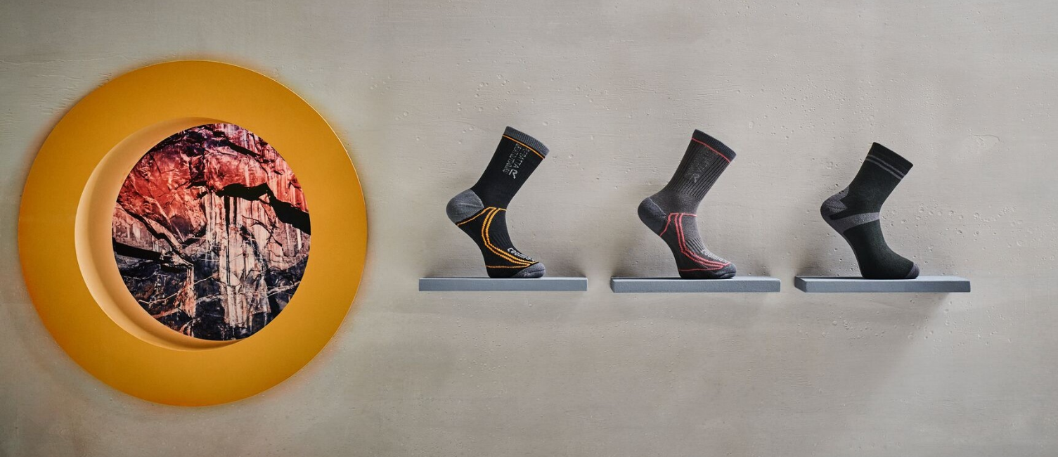 Three walking socks displayed on shelves