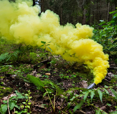 A colorful smoky smoke candle during an airsoft game