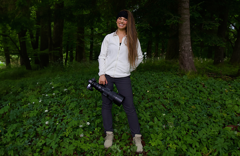 Hannah Stitfall in Craghoppers clothing carrying a camera