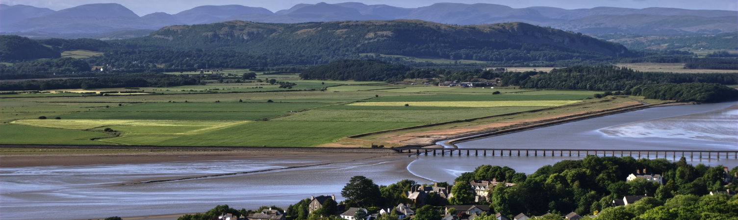 A view from Arnside Knot, a beauty spot in Cumbria, Northern England. The Kent Estuary, Arnside Viaduct, and the Lakeland Fells