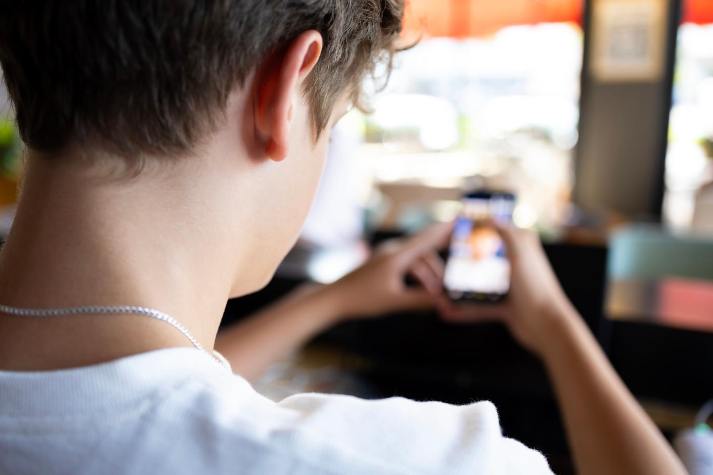 Teenager looking at smartphone
