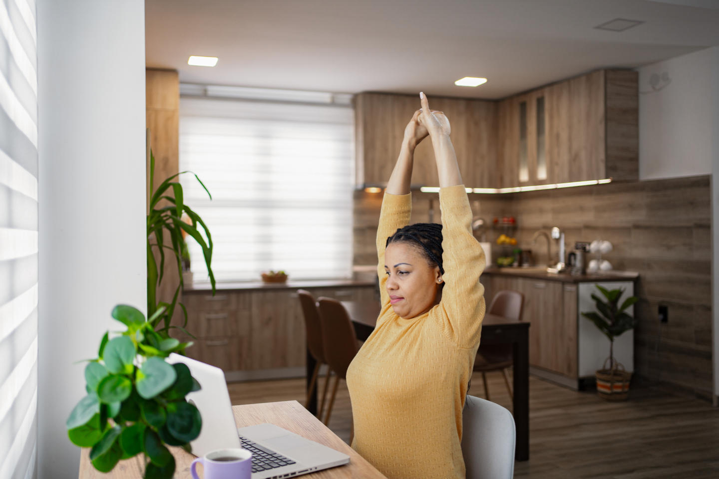 Person stretching at their desk while working from home